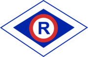 Grafika symbolu ruchu drogowego czyli litery r w rombie.